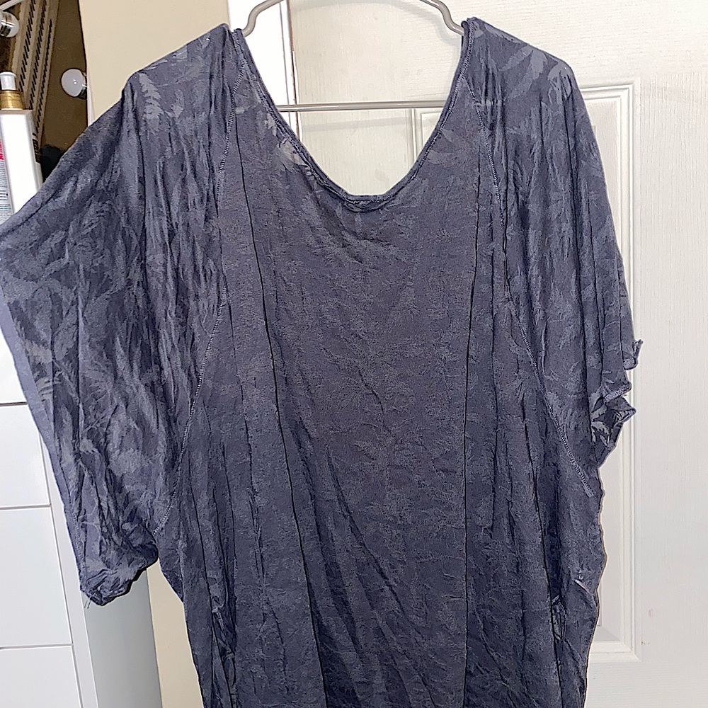 Free People gray short sleeve tee that has floral patterns around the tee